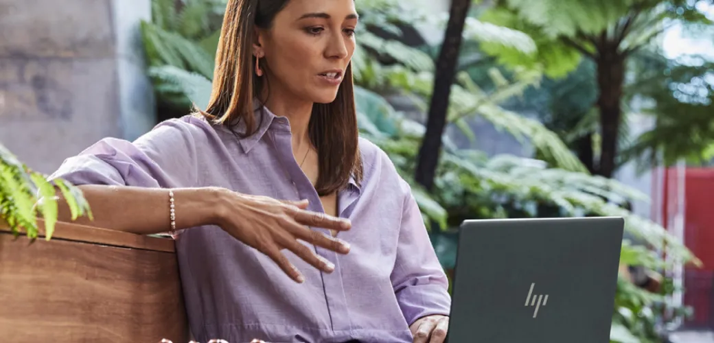Woman video conferencing outdoors on an HP Laptop
