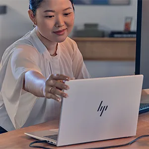 Woman opening her HP EliteBook 8 G1a laptop